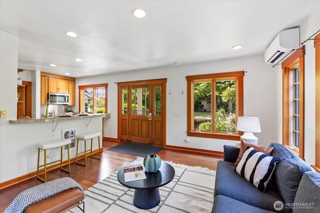 21908 36th Ave W, Brier, WA 98036 - living room featuring a wall mounted AC, wood finished floors, and recessed lighting
