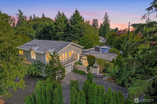 21908 36th Ave W, Brier, WA 98036 - view of front of home featuring a balcony, asphalt driveway, stucco siding, a garage, and roof with shingles