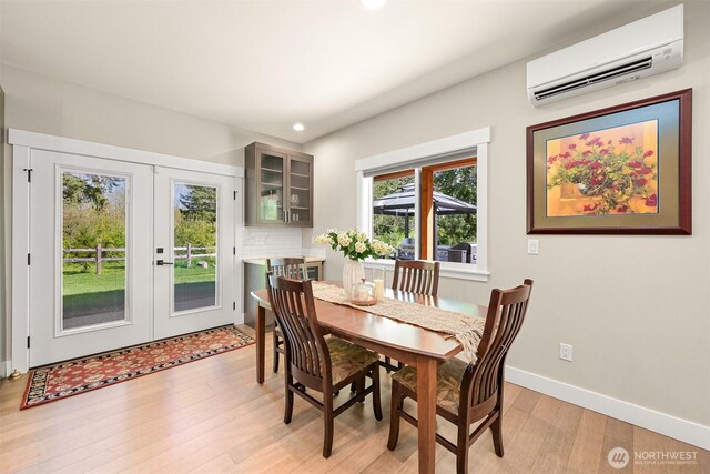 1699 Skagit St, Bellingham, WA 98226 - dining space featuring light wood-type flooring, an AC wall unit, baseboards, recessed lighting, and french doors