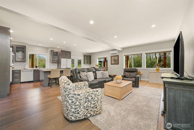 1699 Skagit St, Bellingham, WA 98226 - living area with a wall mounted air conditioner, recessed lighting, beamed ceiling, and wood finished floors