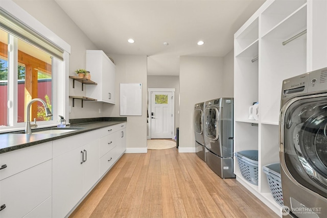 1699 Skagit St, Bellingham, WA 98226 - clothes washing area featuring independent washer and dryer, recessed lighting, a sink, light wood finished floors, and cabinet space
