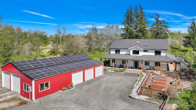 1699 Skagit St, Bellingham, WA 98226 - view of front of property with a shingled roof, an outdoor structure, a detached garage, and covered porch