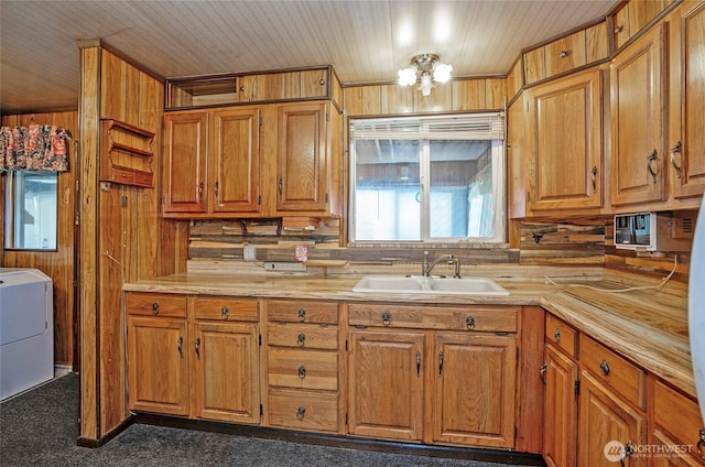 1257 S Ridgewood Ave, Tacoma, WA 98405 - kitchen with light countertops, brown cabinets, a sink, and washer / dryer