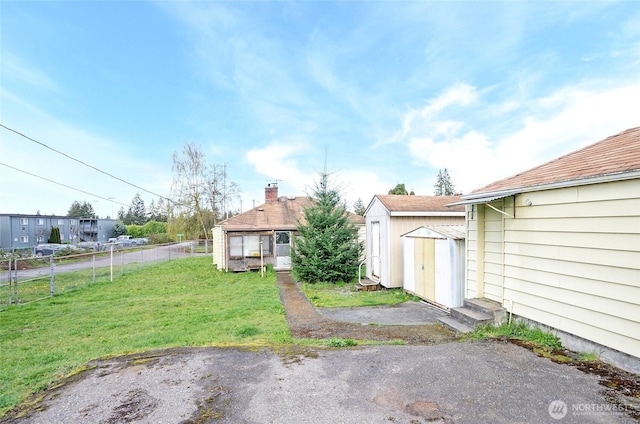 1257 S Ridgewood Ave, Tacoma, WA 98405 - view of yard with a storage shed, fence, and an outbuilding