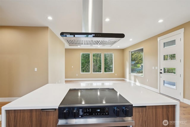 kitchen with recessed lighting, open floor plan, electric range, and island exhaust hood