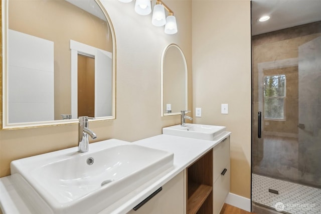 full bathroom featuring a sink, a shower stall, double vanity, and recessed lighting