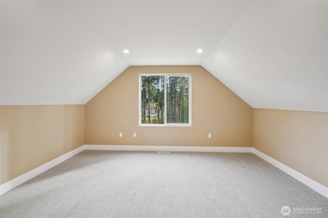 additional living space featuring baseboards, recessed lighting, light colored carpet, and vaulted ceiling