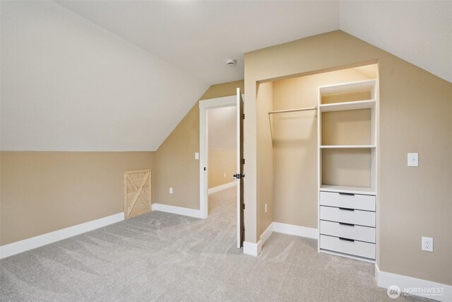 bonus room with carpet and lofted ceiling