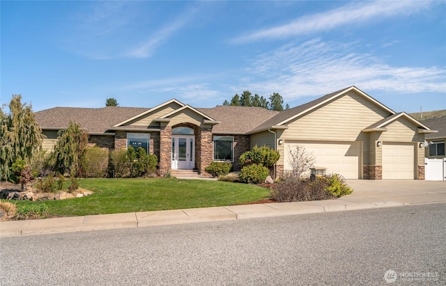 107 Springhill Dr, East Wenatchee, WA 98802 - single story home featuring concrete driveway, stone siding, a front yard, a garage, and a shingled roof