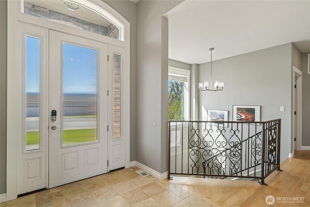 107 Springhill Dr, East Wenatchee, WA 98802 - foyer entrance featuring visible vents, baseboards, and an inviting chandelier