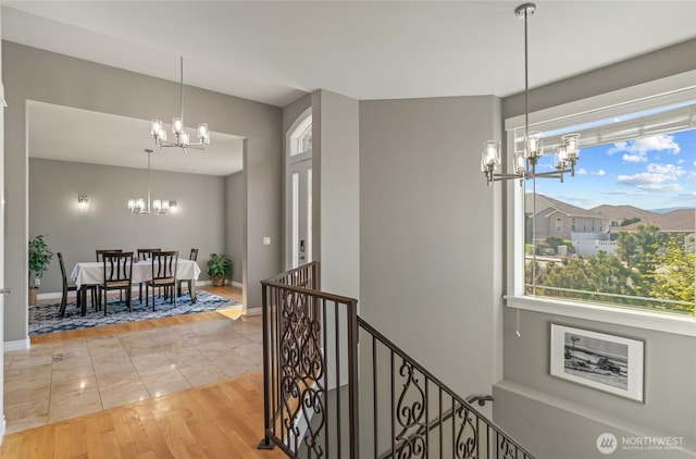 107 Springhill Dr, East Wenatchee, WA 98802 - corridor with an upstairs landing, a notable chandelier, baseboards, and light wood finished floors