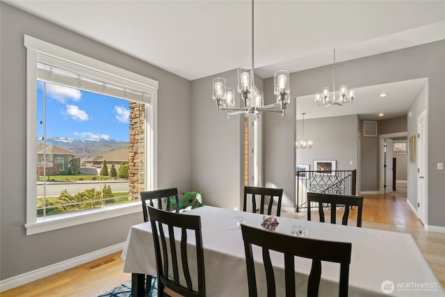 107 Springhill Dr, East Wenatchee, WA 98802 - dining space featuring light wood finished floors, an inviting chandelier, visible vents, and plenty of natural light
