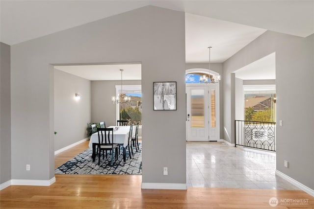 107 Springhill Dr, East Wenatchee, WA 98802 - foyer entrance with lofted ceiling, a notable chandelier, baseboards, and a healthy amount of sunlight