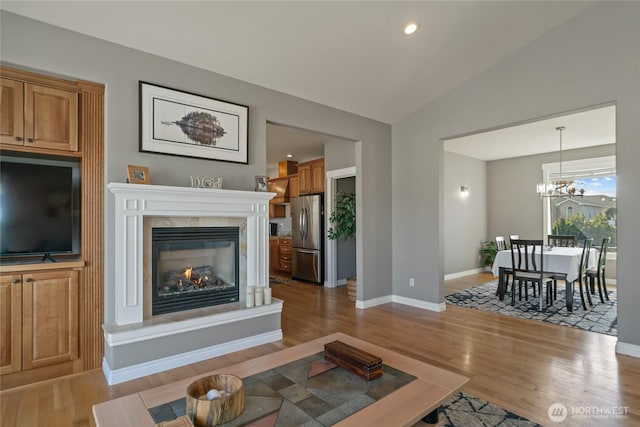 107 Springhill Dr, East Wenatchee, WA 98802 - living room with wood finished floors, a glass covered fireplace, and vaulted ceiling
