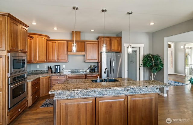 107 Springhill Dr, East Wenatchee, WA 98802 - kitchen with a sink, brown cabinetry, appliances with stainless steel finishes, and dark wood-type flooring