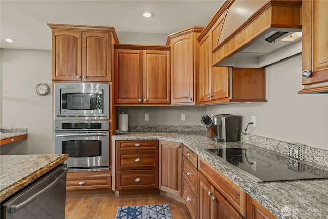 107 Springhill Dr, East Wenatchee, WA 98802 - kitchen featuring custom range hood, light stone countertops, recessed lighting, and stainless steel appliances