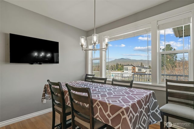 107 Springhill Dr, East Wenatchee, WA 98802 - dining room with a chandelier, wood finished floors, a mountain view, and baseboards