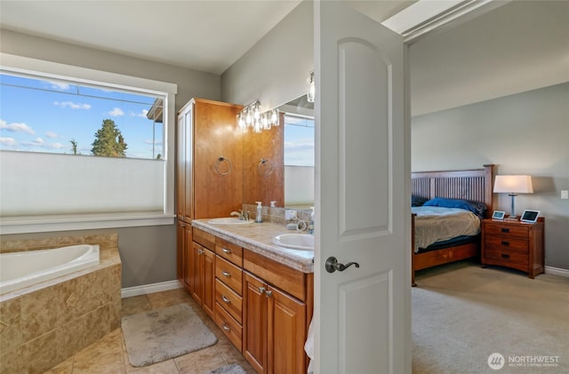 107 Springhill Dr, East Wenatchee, WA 98802 - ensuite bathroom featuring ensuite bath, a sink, a relaxing tiled tub, double vanity, and baseboards