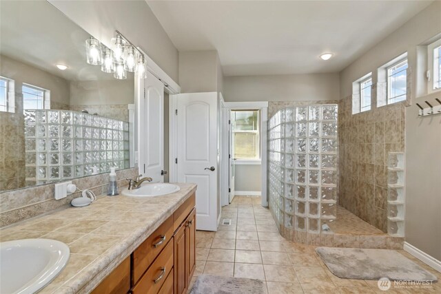 107 Springhill Dr, East Wenatchee, WA 98802 - full bath featuring tile patterned floors, a walk in shower, double vanity, and a sink