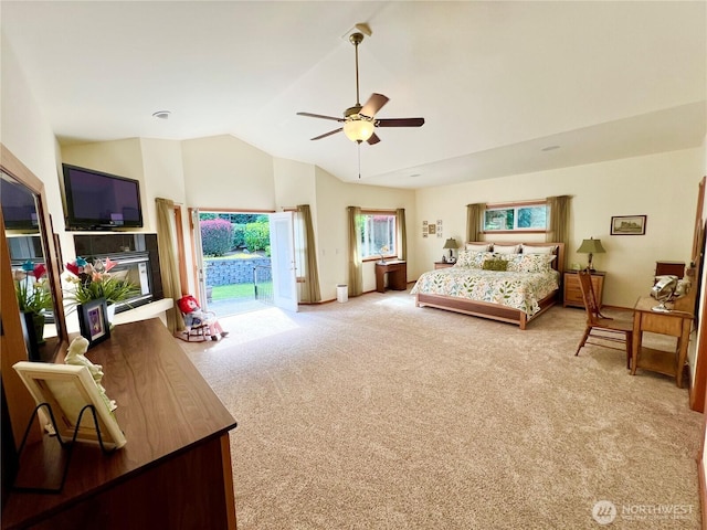 bedroom featuring ceiling fan, vaulted ceiling, carpet flooring, and access to exterior