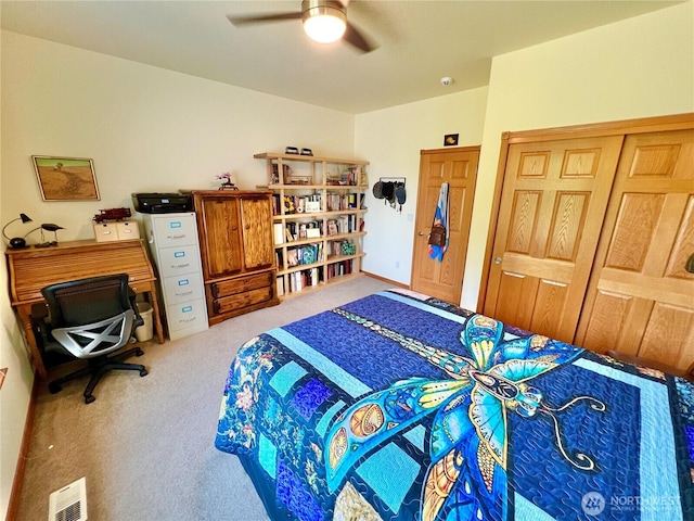 bedroom with a ceiling fan, carpet flooring, and visible vents