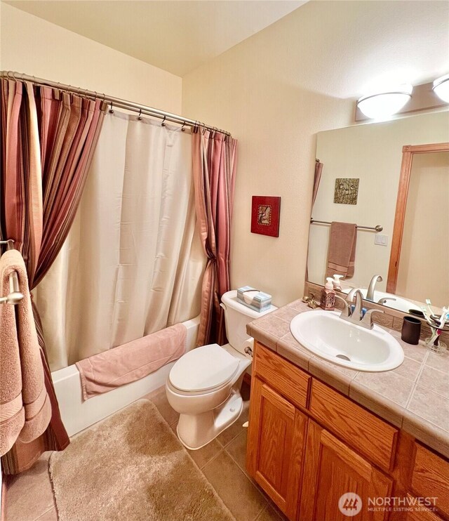 bathroom with shower / tub combo, toilet, vanity, and tile patterned flooring