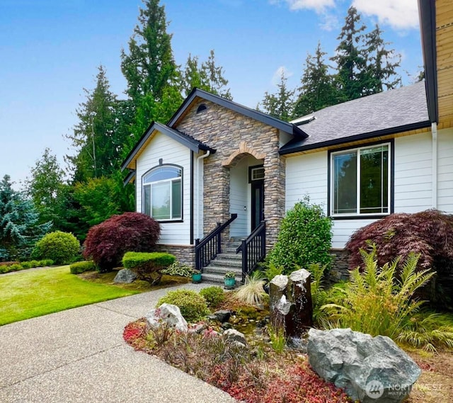 view of front of property with stone siding and a front lawn