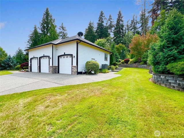 view of side of property with a lawn, central AC unit, and driveway
