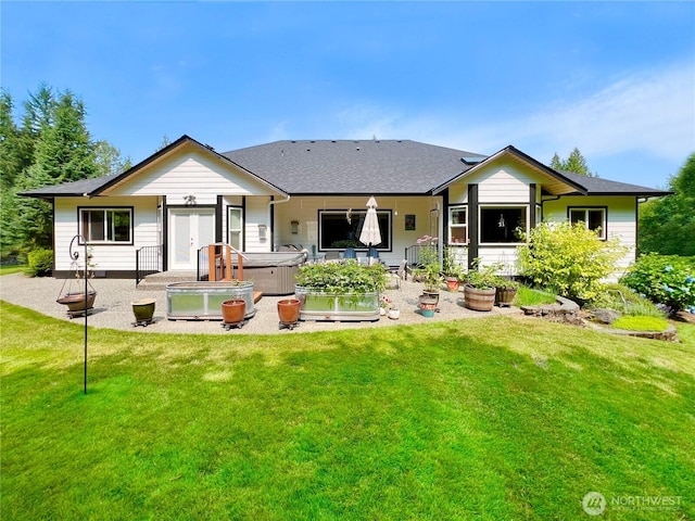 rear view of property with a yard, french doors, a hot tub, and a patio