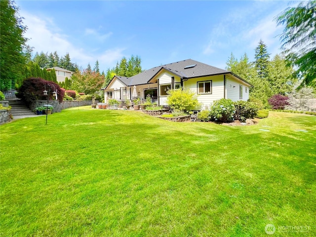 rear view of house with a lawn