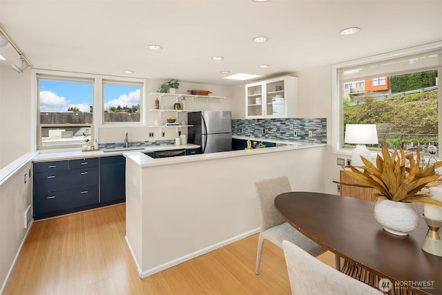 510 Lakeside Ave S Unit 10, Seattle, WA 98144 - kitchen with a sink, light countertops, freestanding refrigerator, and light wood finished floors