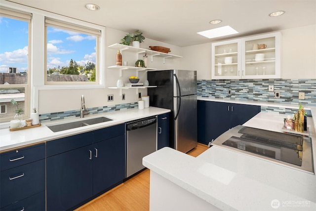 510 Lakeside Ave S Unit 10, Seattle, WA 98144 - kitchen featuring tasteful backsplash, blue cabinets, a sink, and appliances with stainless steel finishes