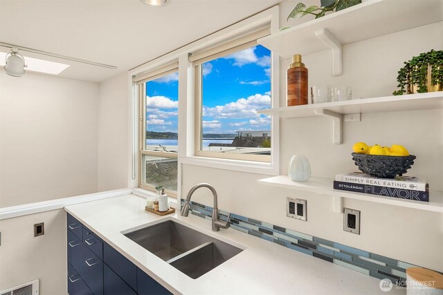510 Lakeside Ave S Unit 10, Seattle, WA 98144 - kitchen featuring a sink, open shelves, visible vents, a water view, and blue cabinets
