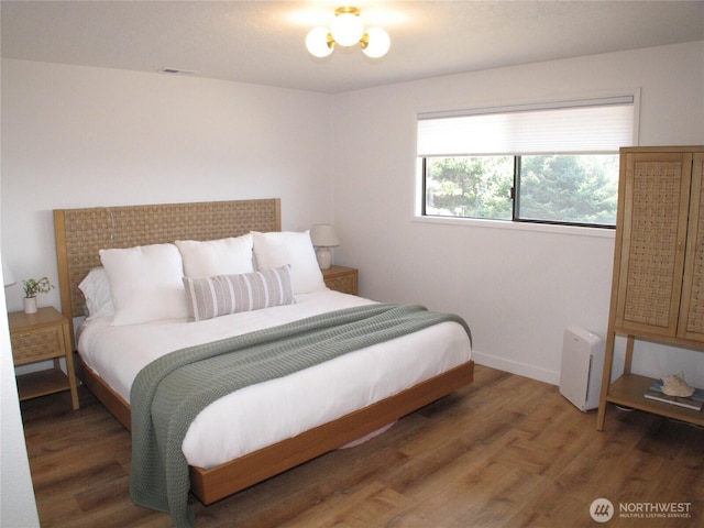 bedroom with light wood-style flooring, baseboards, and visible vents