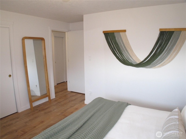bedroom with wood finished floors