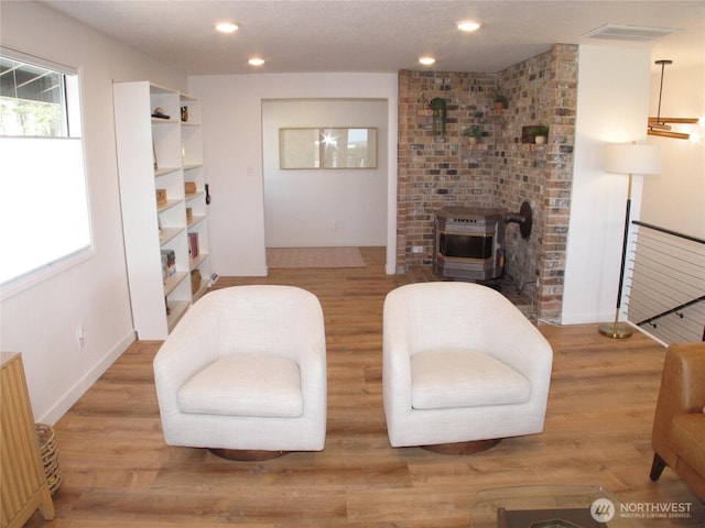 living area featuring recessed lighting, baseboards, and wood finished floors