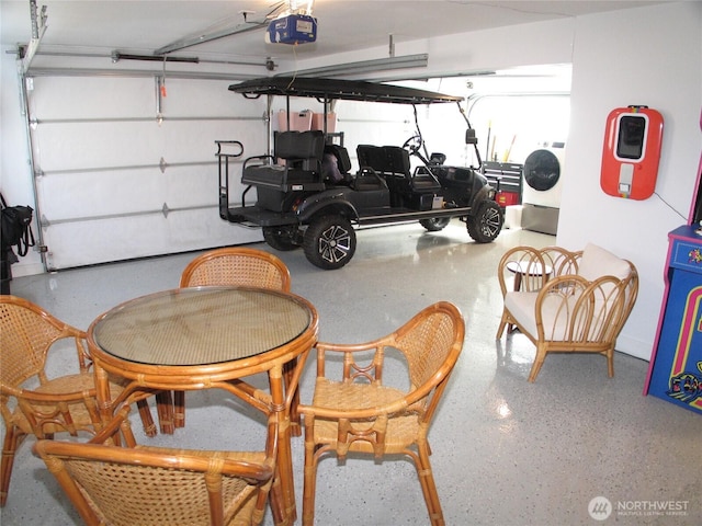 garage with a garage door opener and washer / dryer