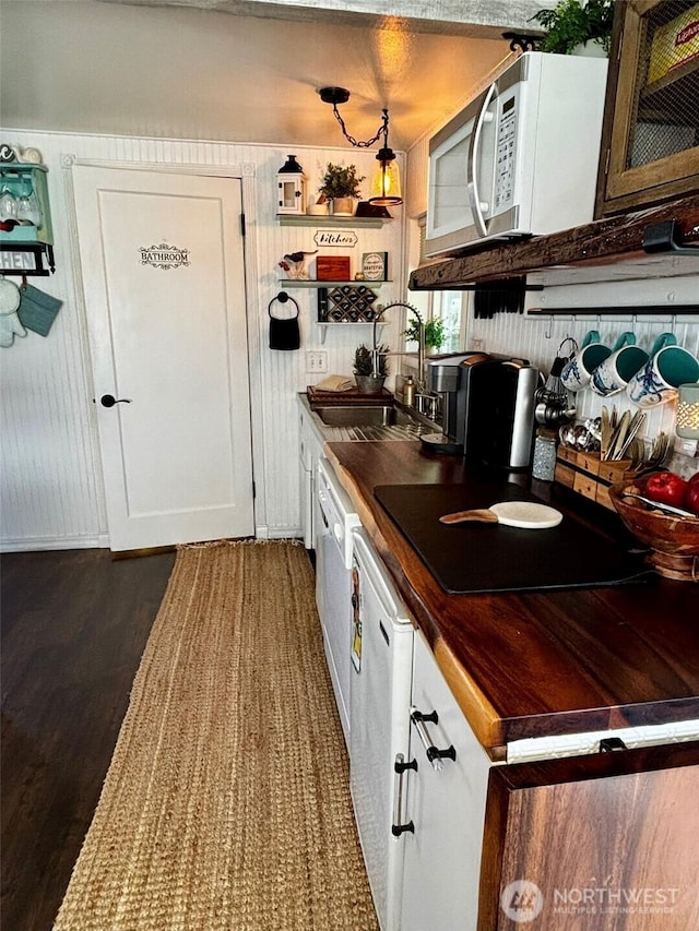 4216 N Pl, Seaview, WA 98644 - kitchen with white cabinetry, dark wood-style flooring, a sink, and white microwave