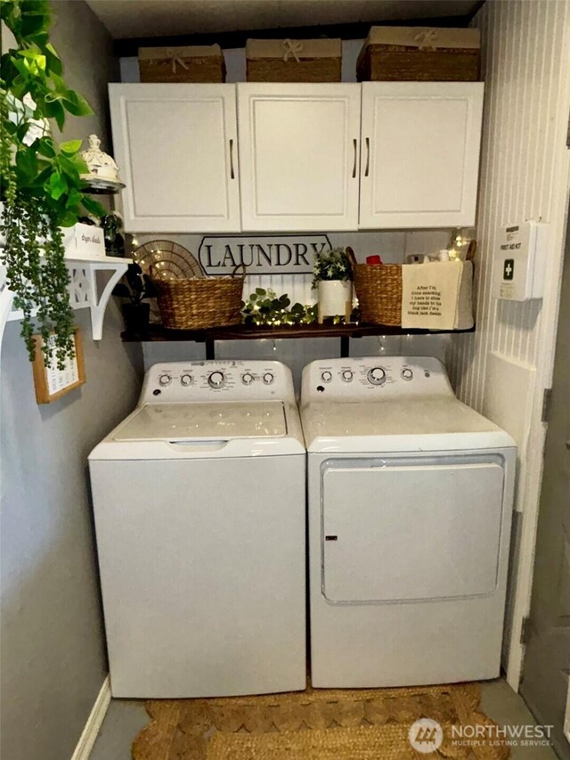 4216 N Pl, Seaview, WA 98644 - clothes washing area featuring cabinet space, baseboards, and separate washer and dryer