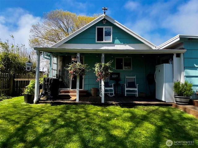 4216 N Pl, Seaview, WA 98644 - rear view of house featuring a lawn and fence