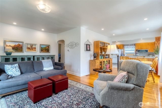 721 Main St, Waitsburg, WA 99361 - living room featuring recessed lighting, baseboards, arched walkways, and light wood-type flooring