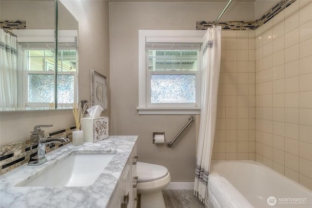 721 Main St, Waitsburg, WA 99361 - bathroom featuring toilet, baseboards, vanity, and a healthy amount of sunlight