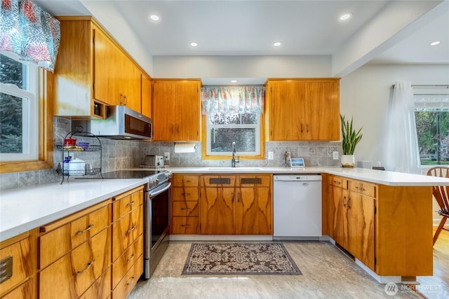 721 Main St, Waitsburg, WA 99361 - kitchen featuring a peninsula, stainless steel appliances, light countertops, and a sink