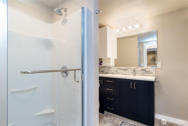 721 Main St, Waitsburg, WA 99361 - full bath with decorative backsplash, baseboards, vanity, and a stall shower