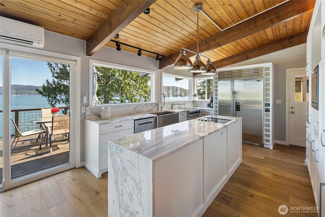162 Sea Ranch Rd, Lopez Island, WA 98261 - kitchen featuring wood ceiling, a sink, appliances with stainless steel finishes, a kitchen island, and an AC wall unit