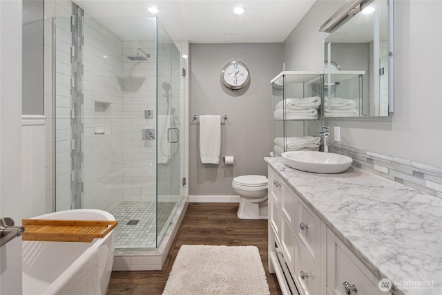 162 Sea Ranch Rd, Lopez Island, WA 98261 - full bath with a soaking tub, wood finished floors, a stall shower, and vanity