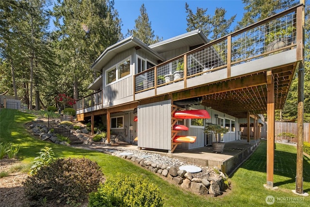 162 Sea Ranch Rd, Lopez Island, WA 98261 - rear view of house with a lawn, a wooden deck, a patio, and fence