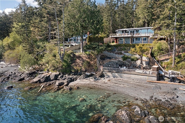 162 Sea Ranch Rd, Lopez Island, WA 98261 - exterior space with a deck with water view, a forest view, and stairs