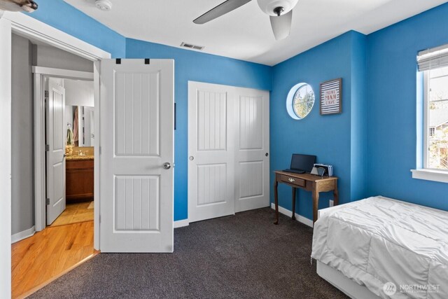 carpeted bedroom featuring baseboards, visible vents, a ceiling fan, and a closet