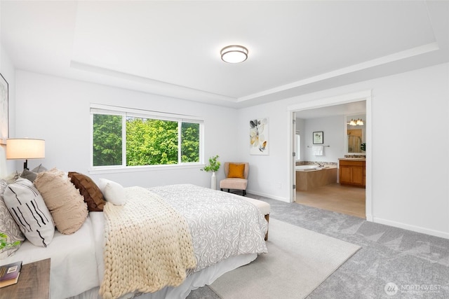 3262 NE Marquette Way, Issaquah, WA 98029 - bedroom featuring a tray ceiling, light colored carpet, baseboards, and ensuite bathroom